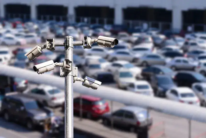 CCTV cameras overlooking a busy vehicle yard.